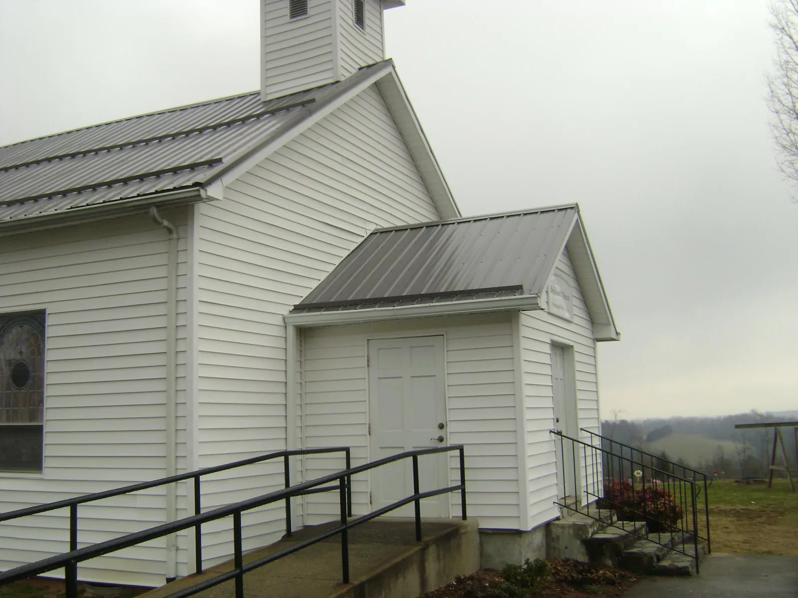 Gray metal roof on a white clapboard church with a steeple in Lexington
